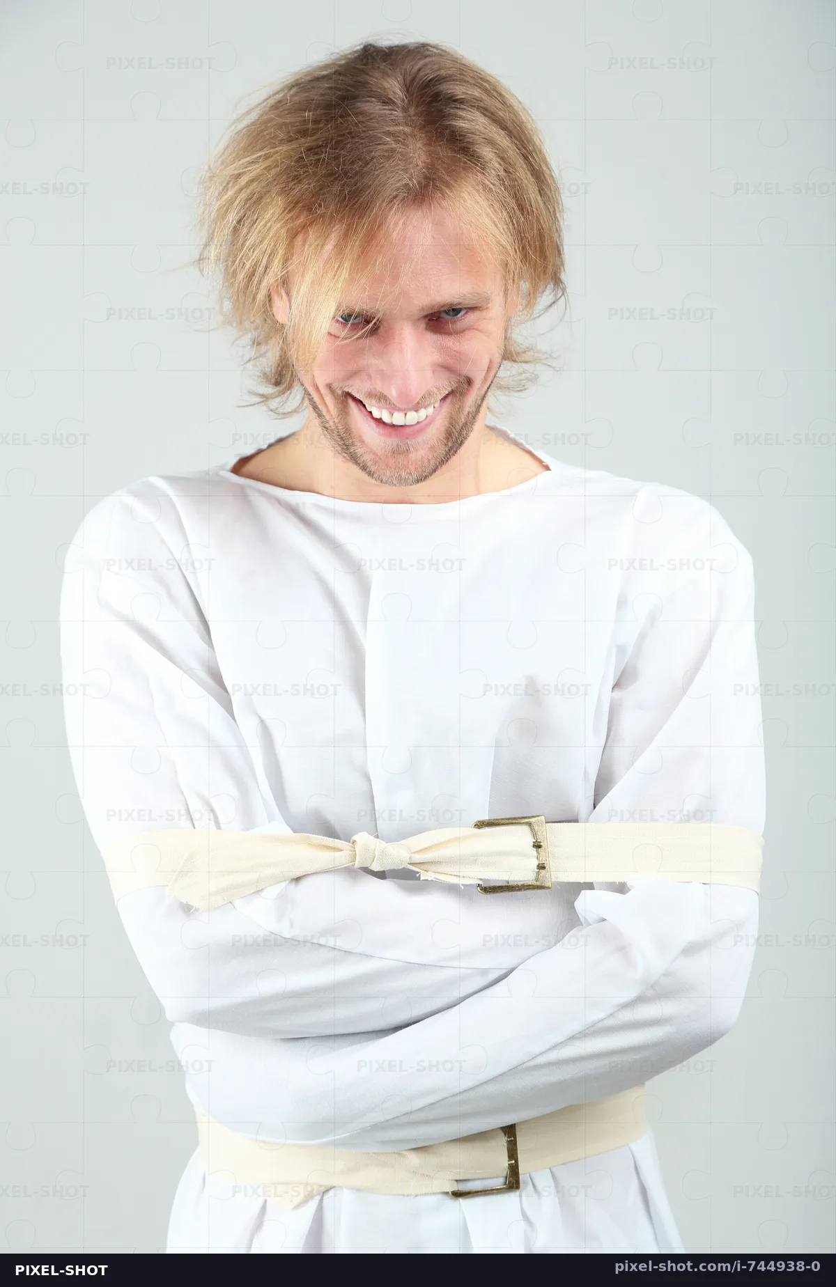 mentally-ill-man-in-strait-jacket-on-gra